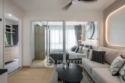 Modern living room with stylish decor and view into cozy bedroom