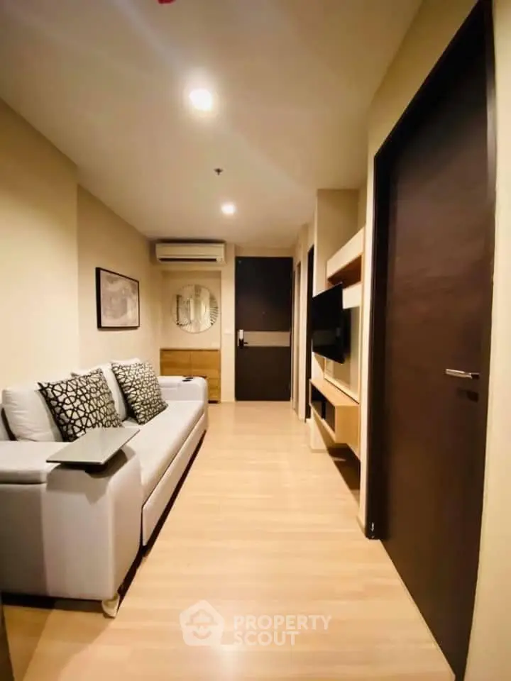 Cozy living room with modern decor and comfortable seating in a stylish apartment.