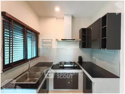 Modern kitchen with sleek cabinetry and gas stove in a stylish apartment
