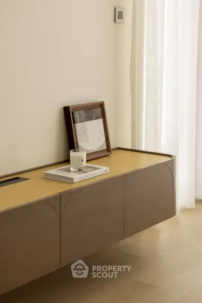 Minimalist interior with modern wooden console and decor accents