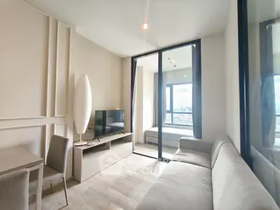 Modern living room with sleek furniture and city view, perfect for urban living.