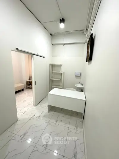 Minimalist white room with modern tile flooring and sleek furniture