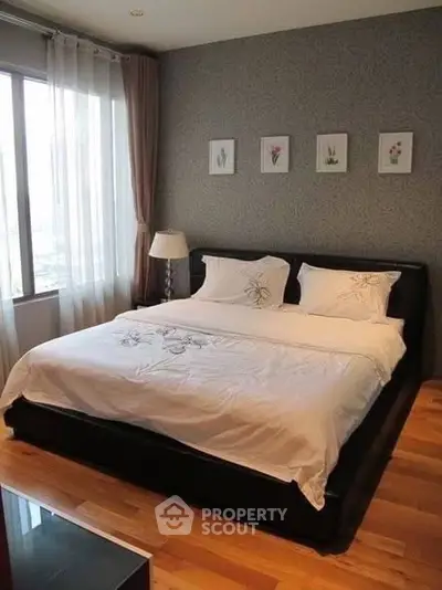 Elegant bedroom with large bed and natural light from window