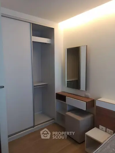 Modern bedroom with sleek sliding wardrobe and stylish vanity area