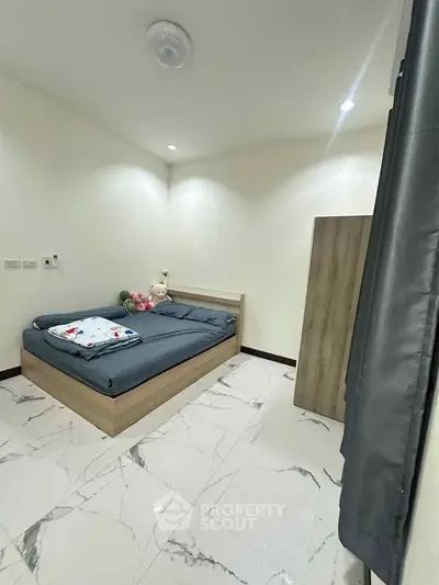 Modern minimalist bedroom with sleek design and marble flooring