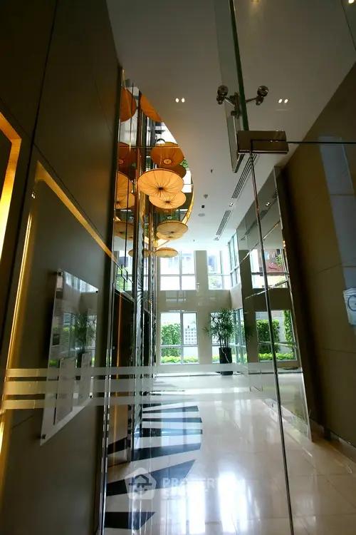 Luxurious modern building entrance with elegant glass doors and stylish lighting