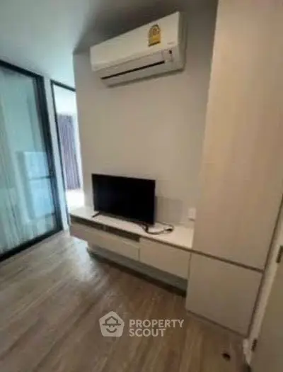 Modern living room with air conditioning and TV unit in stylish apartment.