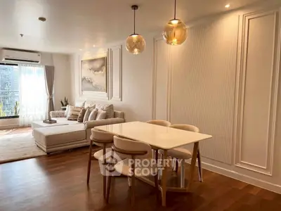 Elegant living room with modern dining area and stylish lighting