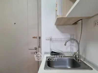 Compact kitchen area with sink and storage, ideal for small apartments.