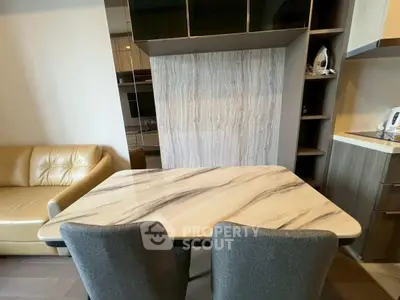 Modern dining area with marble table and cozy seating in stylish apartment