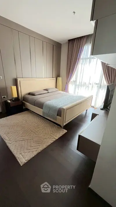 Luxurious bedroom with elegant decor and large window for natural light.