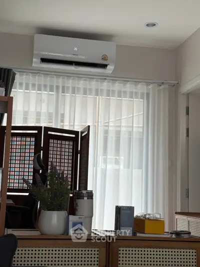 Cozy living room with air conditioning and stylish decor