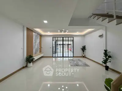 Spacious modern living room with sleek design and large windows for natural light.