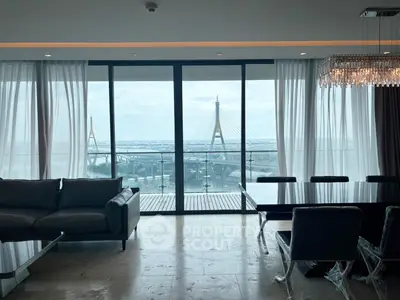 Luxurious living room with stunning city view and elegant furnishings.
