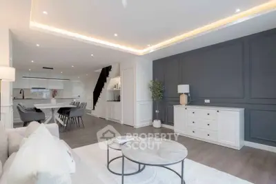 Modern open-plan living room with elegant decor and stylish lighting