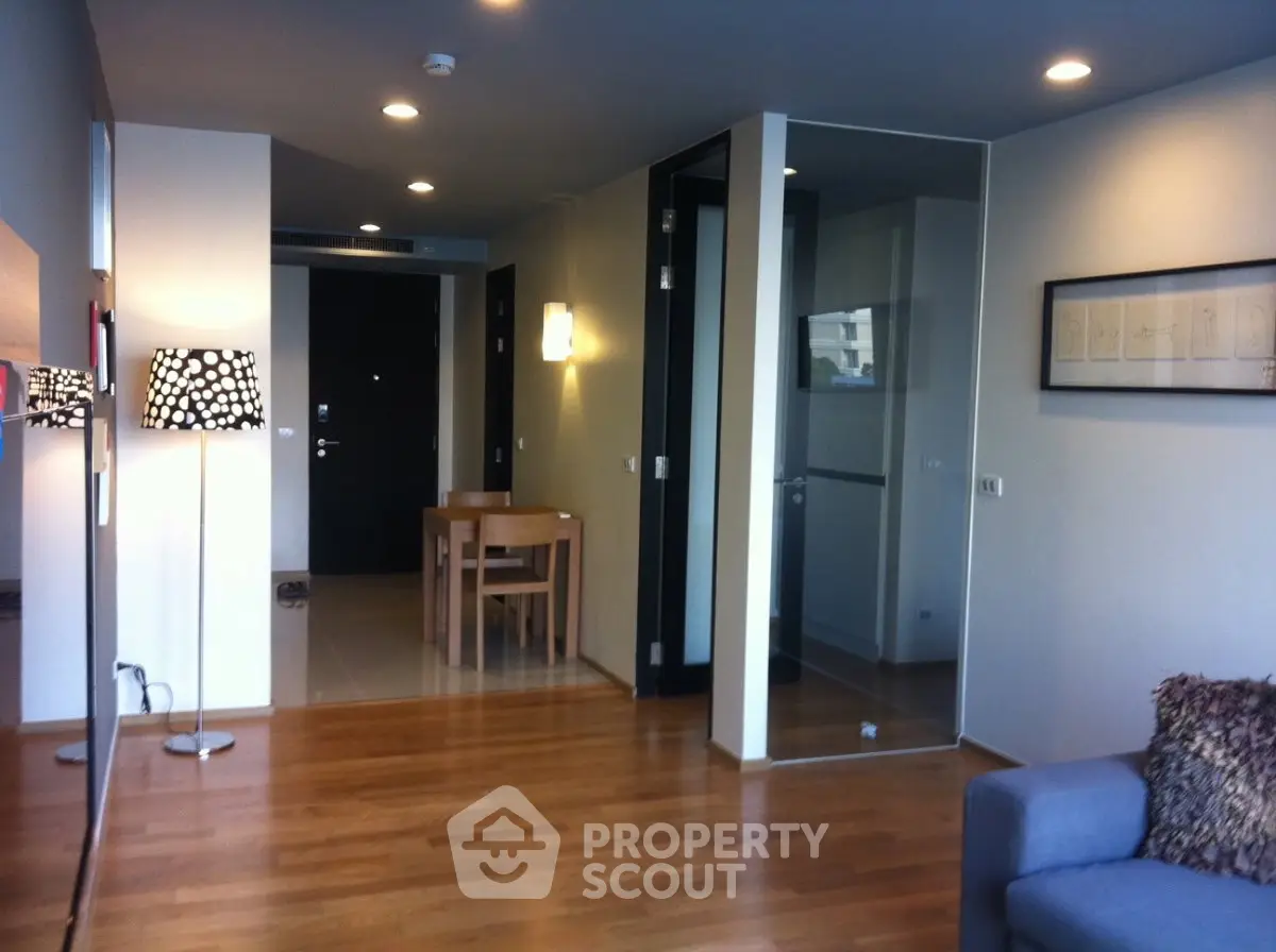 Modern living room with wooden flooring and stylish decor in a contemporary apartment.