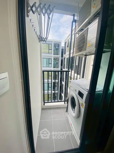 Modern apartment balcony with washing machine and city view