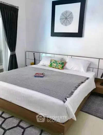 Modern bedroom with stylish decor and cozy bedding in a contemporary home.