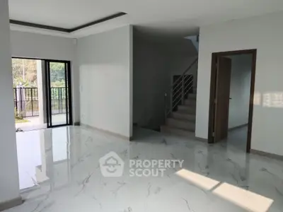 Spacious modern living room with marble floors and staircase