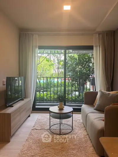 Cozy living room with modern decor and garden view through large window.
