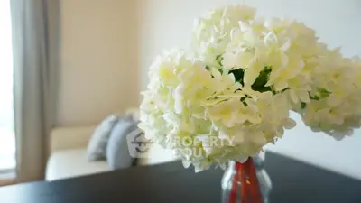 Elegant interior with a cozy living room and stylish floral arrangement, perfect for modern living.