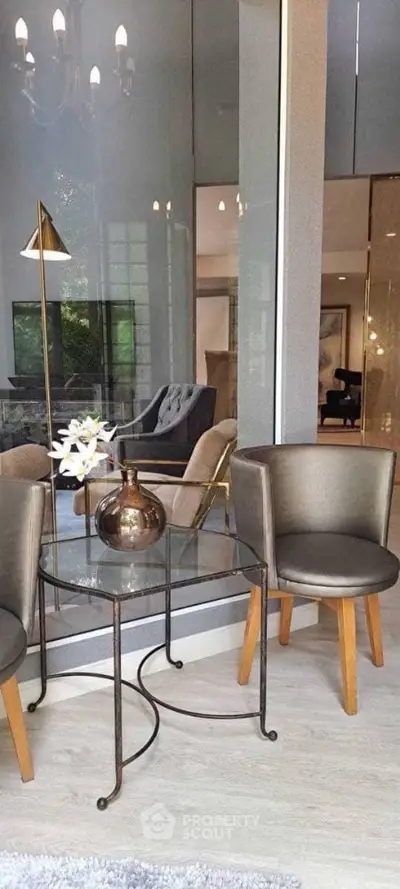 Elegant modern living room with stylish furniture and glass accents