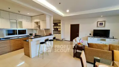 Spacious open-plan living room and kitchen with modern furnishings and sleek design.