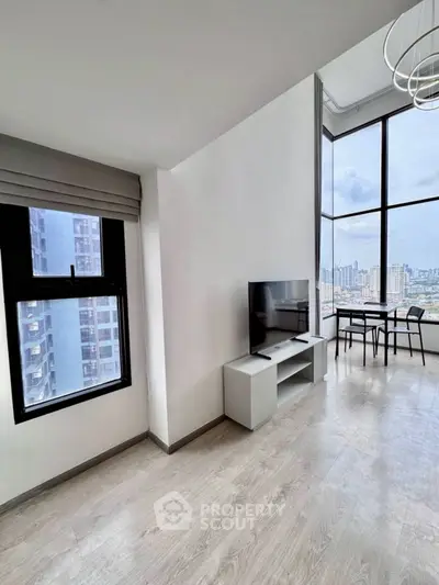 Modern high-rise apartment with stunning city view and sleek interior design.