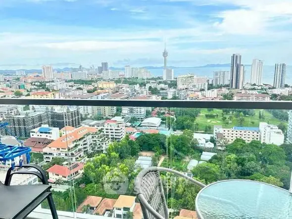 Stunning high-rise balcony view overlooking cityscape and ocean horizon.