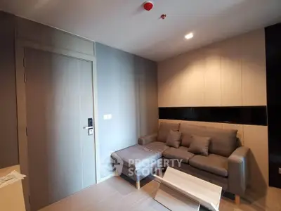 Modern living room with stylish sofa and sleek wooden accents in a cozy apartment.