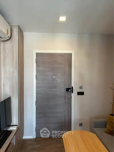 Modern living room with wooden door and sleek furniture design