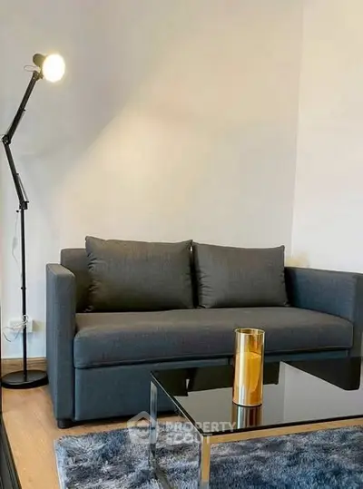 Modern living room with sleek sofa and stylish floor lamp