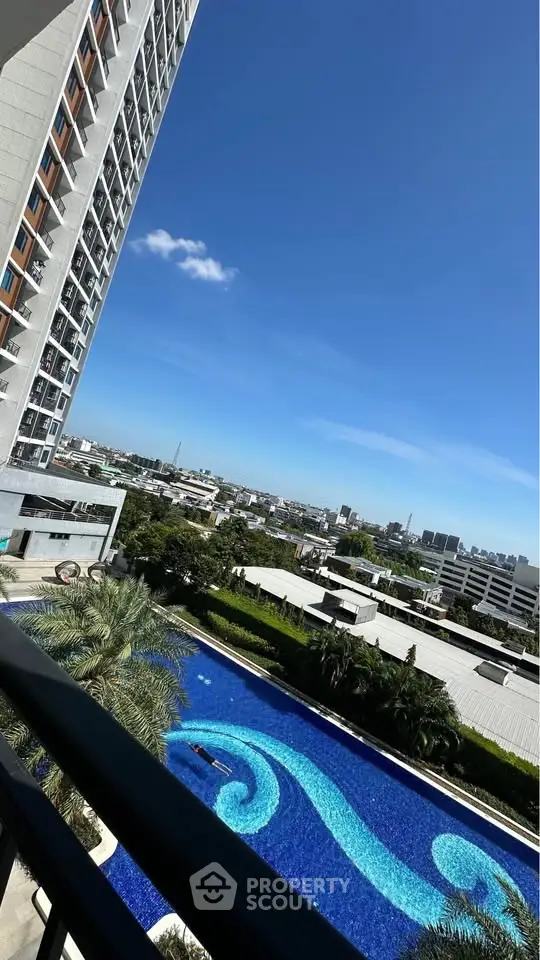 Stunning high-rise view with luxurious pool and cityscape backdrop, perfect for urban living.