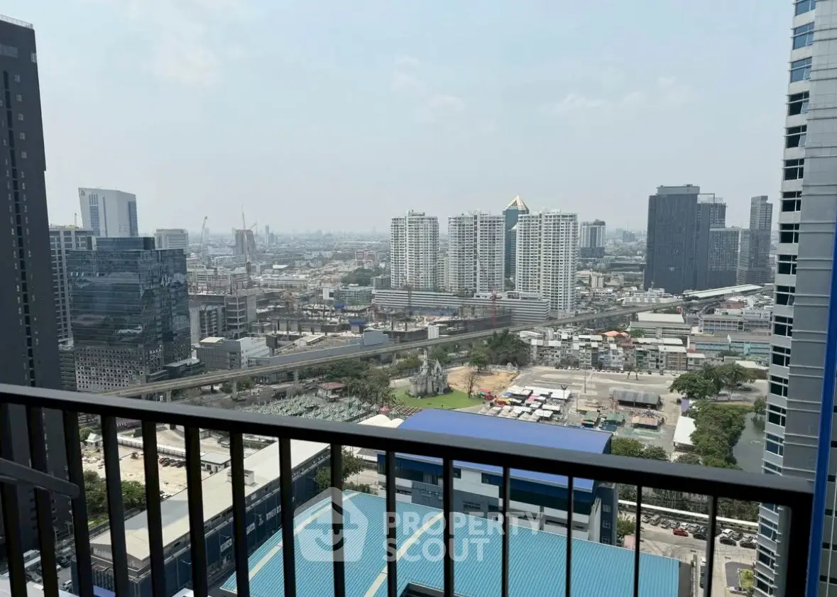 Stunning cityscape view from high-rise balcony overlooking urban skyline.