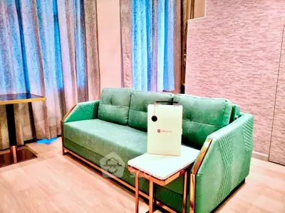 Modern living room with stylish green sofa and elegant decor