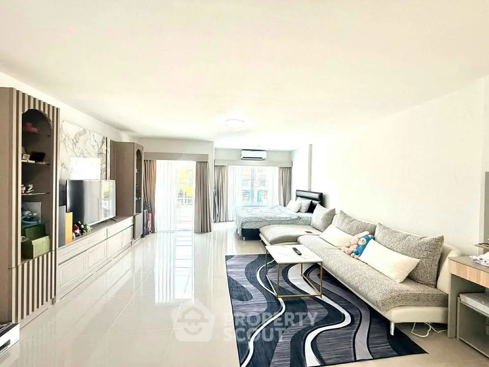 Spacious modern living room with elegant decor and large windows for natural light.