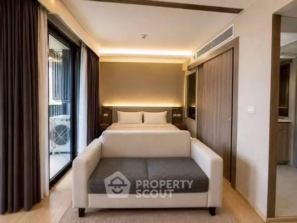 Modern bedroom with stylish decor and balcony view in luxury apartment