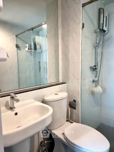Modern bathroom with sleek fixtures and glass shower enclosure