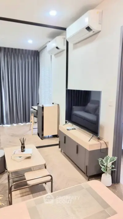 Modern living room with sleek furniture and air conditioning, perfect for comfortable living.