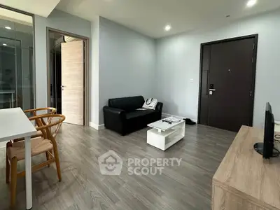 Modern living room with sleek furniture and wooden flooring