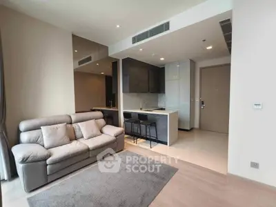 Modern living room with open kitchen and stylish furniture in a contemporary apartment.