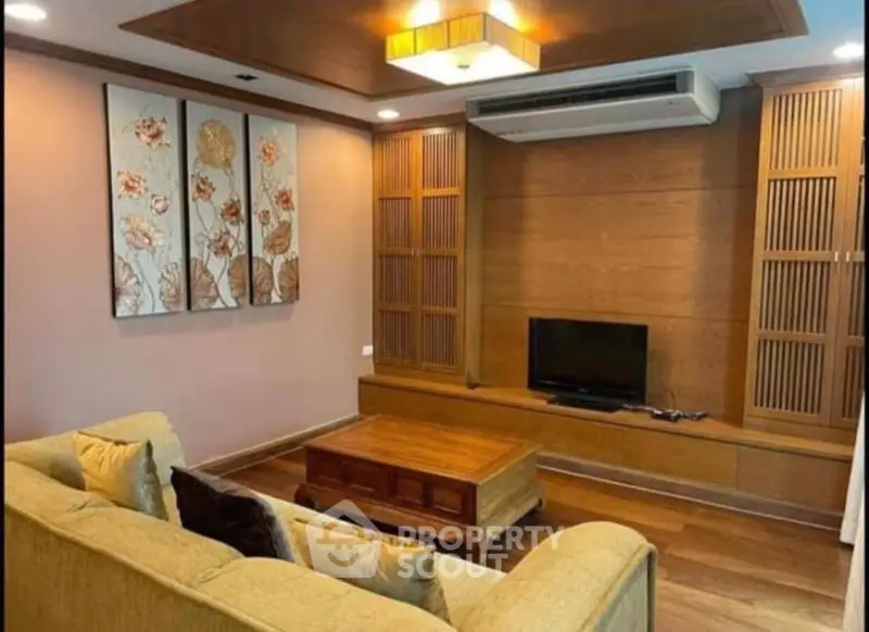 Elegant living room with cozy sofa, wooden accents, and modern decor