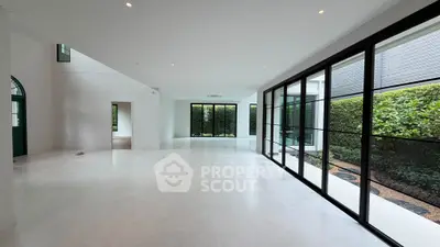 Spacious modern living room with large windows and garden view