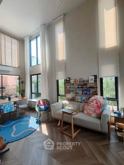Spacious modern living room with high ceilings and large windows