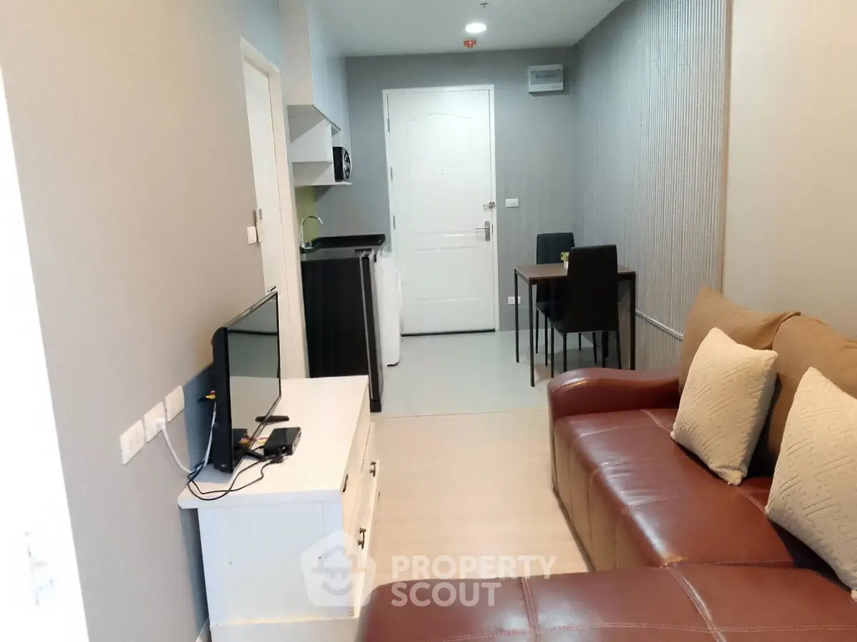 Modern living room with cozy brown sofa and sleek TV setup in stylish apartment.