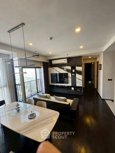 Modern living room with stylish decor and balcony view in a luxury apartment.