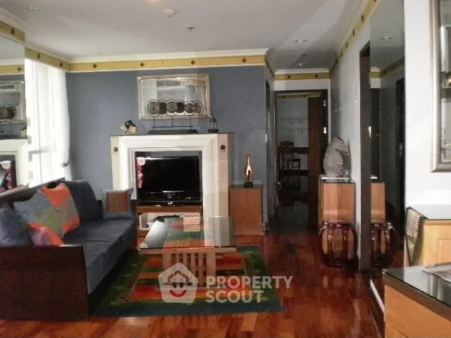 Stylish living room with modern decor and hardwood floors in a luxurious apartment.