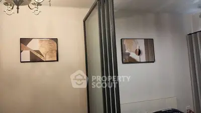 Modern interior with abstract art and stylish lighting in a cozy living space.