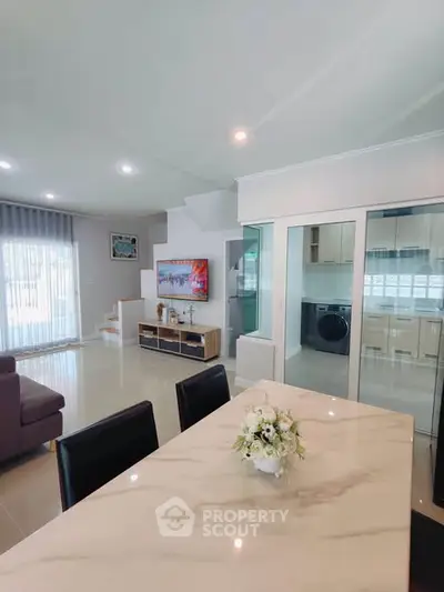 Modern open-plan living room with elegant dining area and stylish kitchen