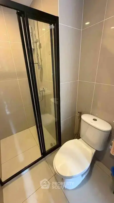 Modern bathroom with sleek shower enclosure and contemporary toilet design.